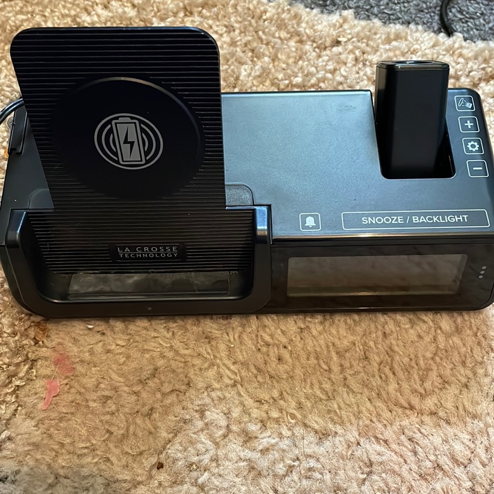 Wireless phone charger and alarm system